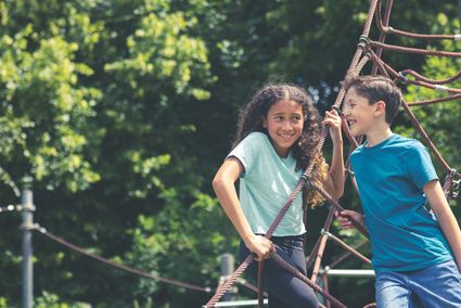 Teens playing on climbing frame